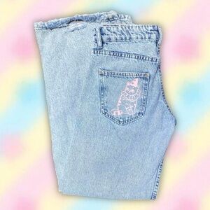 High-waisted light blue baggy jeans with a cute pink cat design